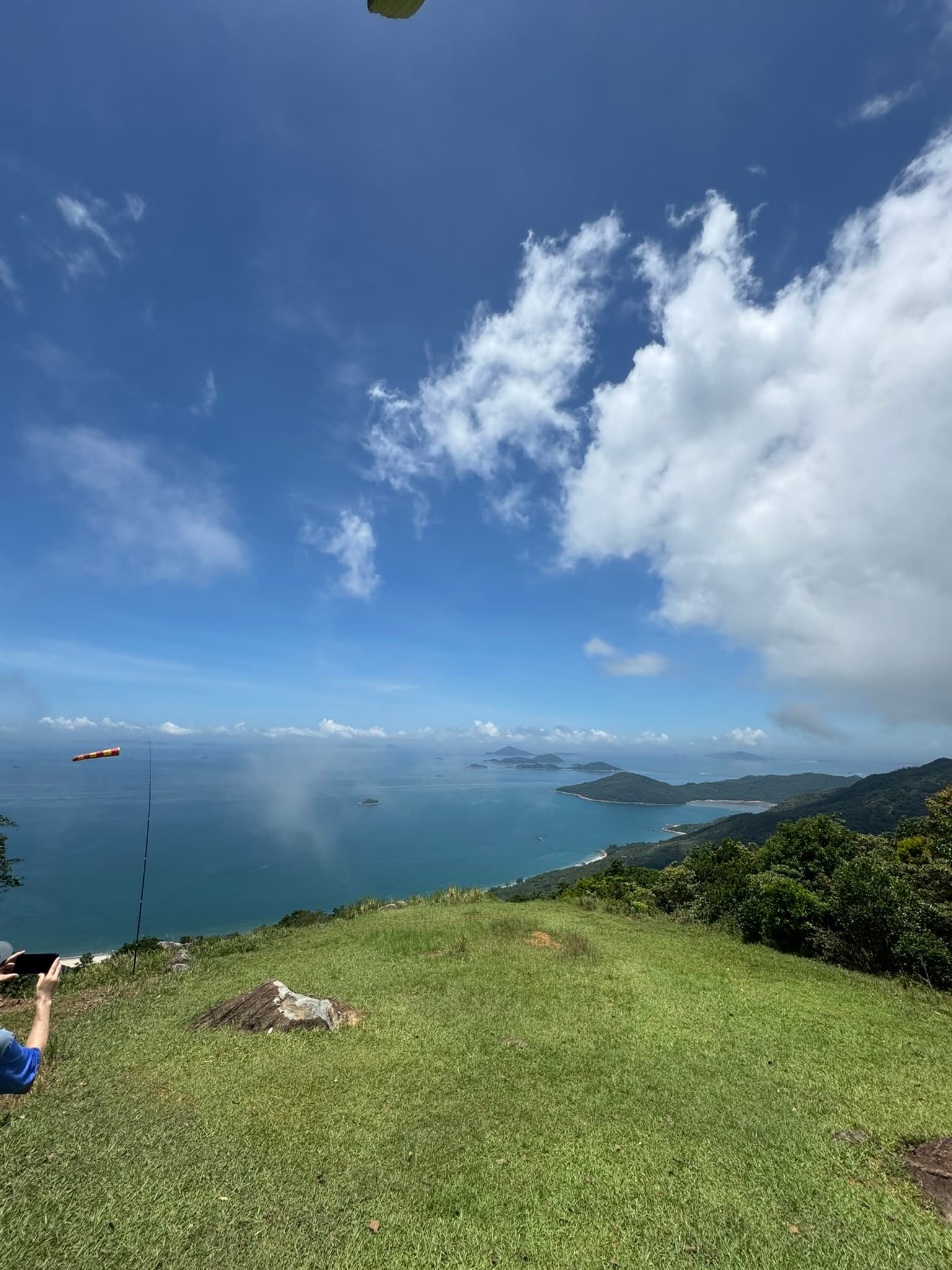 Aerial ocean and ridge line from paragliding harness