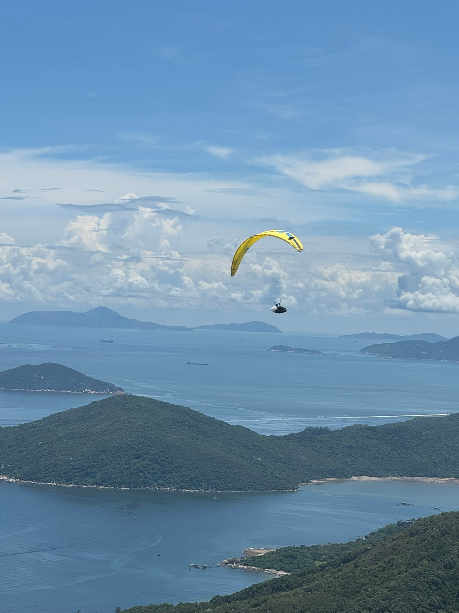 POV view over Hong Kong mountains during tandem paragliding